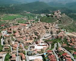 Fontanero Cardona calle adoquinada con casas de piedra medievales y castillo histórico al fondo